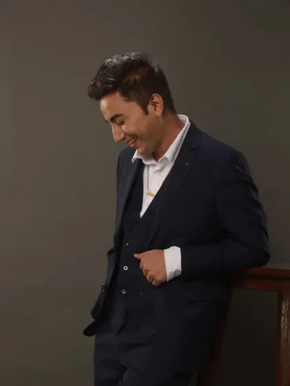 A candid, smiling shot in a three-piece suit. This shows my professional yet approachable personality, perfect for corporate clients and wedding planners.