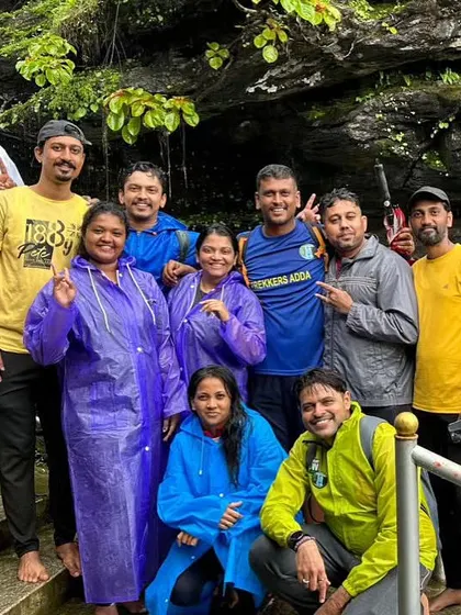 A happy group photo on the steps leading to a waterfall.