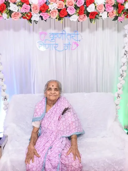 A graceful solo portrait of the great-grandmother-to-be, seated in front of the beautiful floral backdrop.