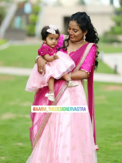 A beautiful mother and daughter twinning in pink. The mother's lehenga and the daughter's frock are perfectly coordinated.