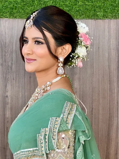 A side profile showcasing the beautiful floral bun created by my sister, Shakshi. It adds a touch of traditional elegance to this modern pastel look.