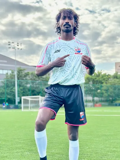 Coach Sunil, a quiet but passionate coach, posing in the new team kit.