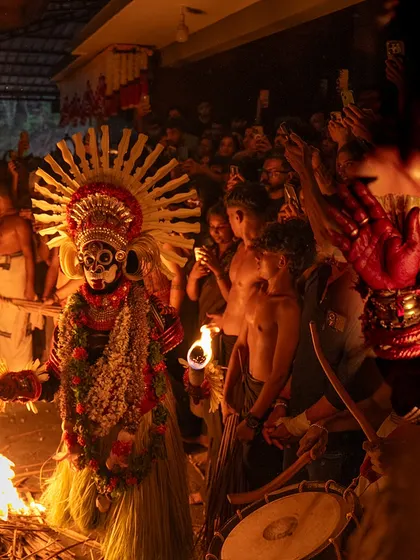 A series showing the Karim Gullikan Theyyam performance, surrounded by devotees and fire. These images document the energy of the crowd and the deity's commanding presence during the ritual.