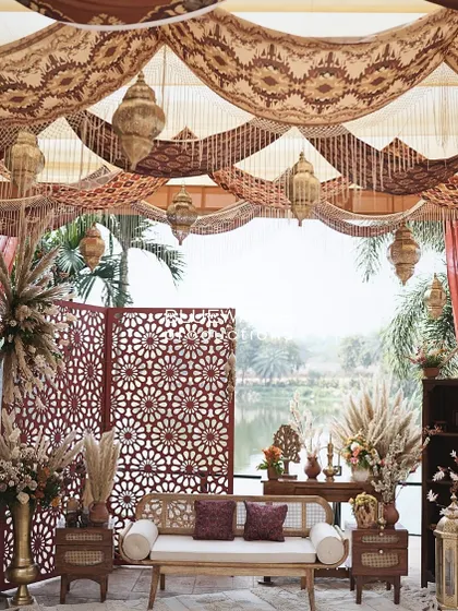 The beautiful lakeside view is framed by the richly decorated Mehendi stage.