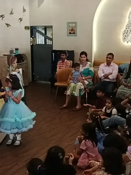 A young guest gets to be part of the magic show, creating a memorable and interactive experience.