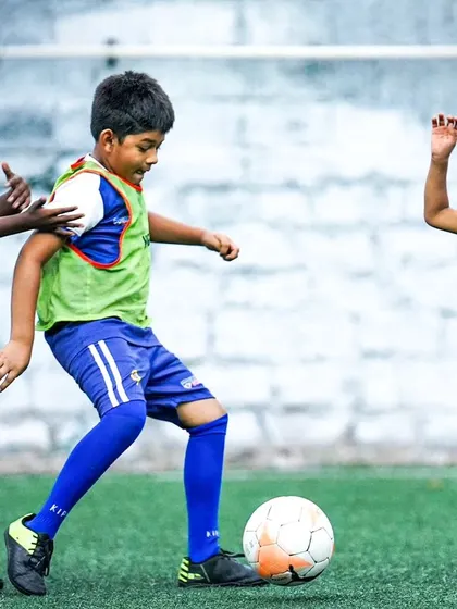 A young player makes a sliding tackle during the Sporthood trials. We love to see passion and commitment on the pitch.