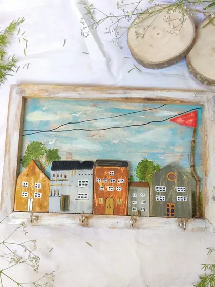 Our miniature house keyholder, beautifully styled with delicate baby's breath. This shows how our functional art can also be a lovely decorative element in your home.