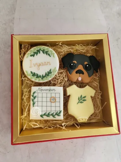 A closer look at the baby announcement cookie set. The details, like the little calendar and the dog's sweet face, make it so personal.