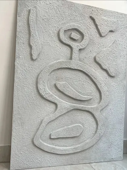 The full view of the abstract textured piece before installation. The asymmetrical, primitive-inspired design is both modern and timeless.