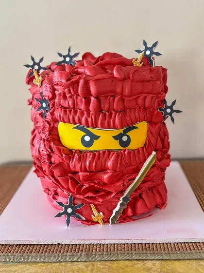The intense eyes of the ninja peeking out from the buttercream mask.