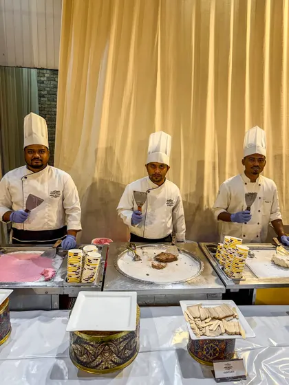 Our team of chefs at a live ice cream roll station, ready to delight guests. This popular counter adds a modern and entertaining touch to any celebration's dessert spread.