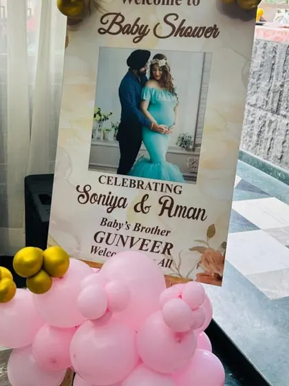 A personalized welcome sign for Soniya & Aman's baby shower, featuring a photo of the couple.