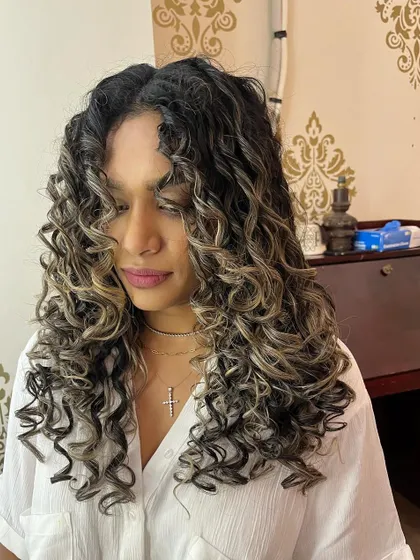The highlights in Tanya's hair pop with the new curl definition.