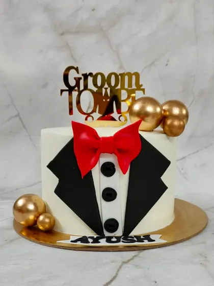 Celebrating the groom-to-be with a cake that's as sharp as his suit. This tuxedo-themed cake is a fun and stylish way to kick off the wedding festivities for the bachelor party or engagement.
