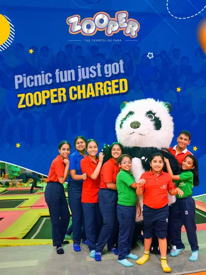 Picnic fun just got Zooper charged. A group of students gathers with our panda mascot, sharing smiles and making memories together.