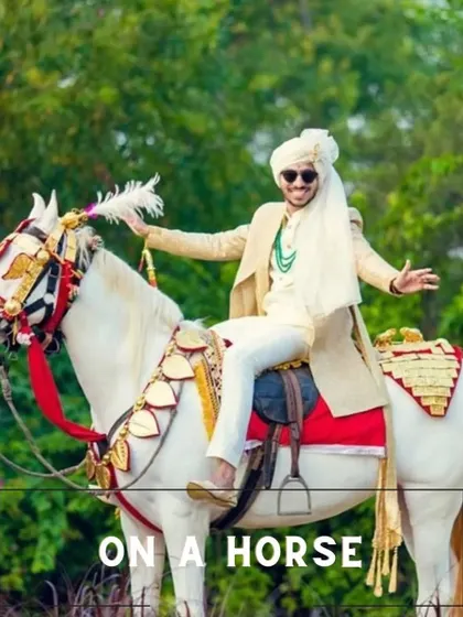 The timeless groom entry on a beautifully decorated white horse (ghodi), a classic choice for a traditional Indian wedding.