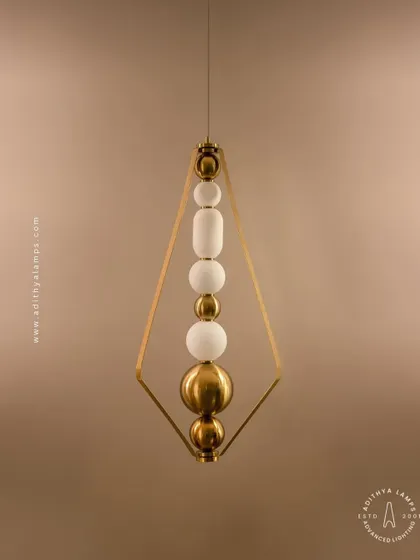 This elegant pendant is framed by a triangular gold structure, enclosing a string of white and gold beads. It's a sophisticated and modern piece that adds a touch of jewelry-like decoration to your space.