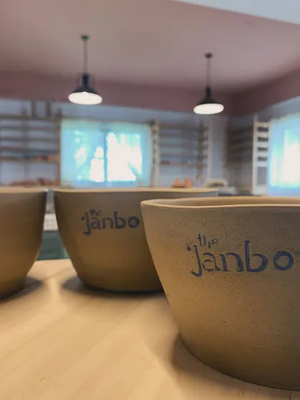 A close-up of our hand-painted bowls, with the studio in the background.