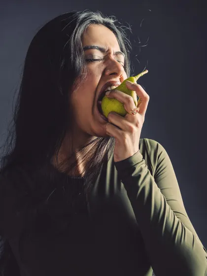 A moment of sensory experience. This shot is about taste and texture, conveyed through the model's expression.