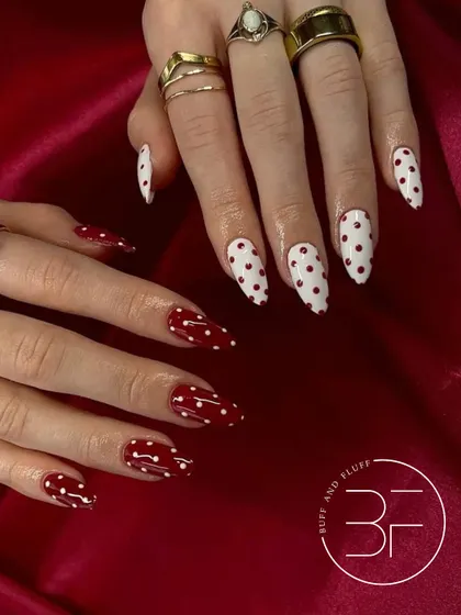 A bold and glamorous take on polka dots. This set features a mix of red-on-white and white-on-red dots for a high-contrast, statement-making manicure.