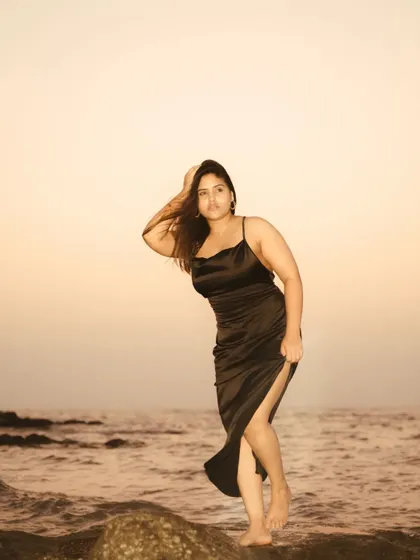 A powerful pose against the sunset sky at the beach. This portrait uses the simple background of the ocean and sky to create a bold and striking silhouette.