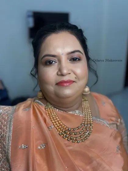 A soft and peachy look for the Sangeet ceremony for the bride's mother. The makeup is fresh and youthful.