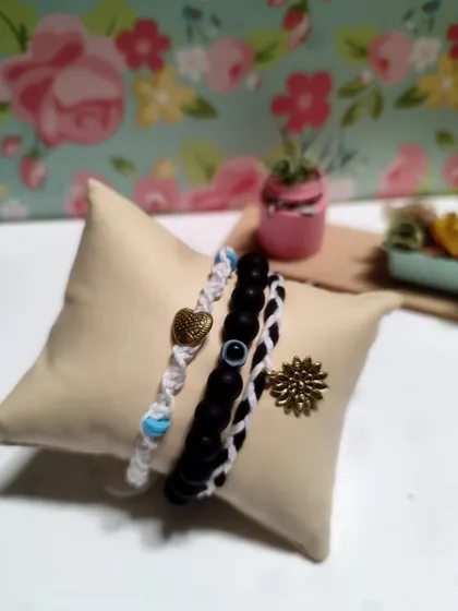 My collection of handmade bracelets, available in many colors and styles. I use beads, evil eye charms, and macrame techniques to create these stackable pieces.