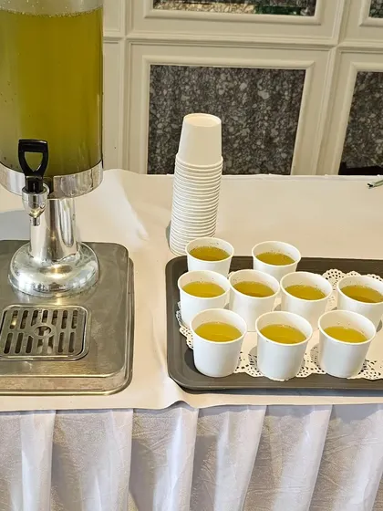 A refreshing welcome drink served from a dispenser, perfect for quenching guests' thirst at a birthday party.