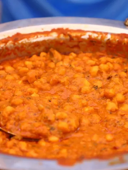 A large serving of Chana Masala, a classic North Indian chickpea curry, ready for the buffet.