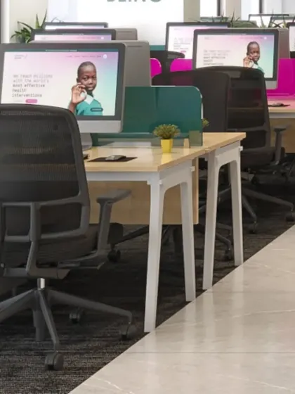A view of the open-plan workstations, designed for functionality and team interaction. We used low, colorful partitions to provide a sense of personal space without sacrificing an open feel.