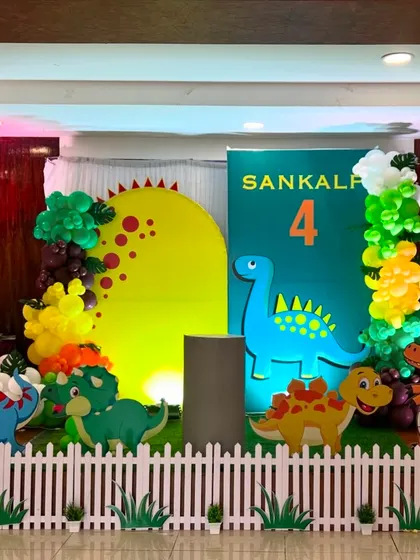 The Dinosaur theme setup under party lighting, creating a fun and exciting atmosphere for a 4th birthday.
