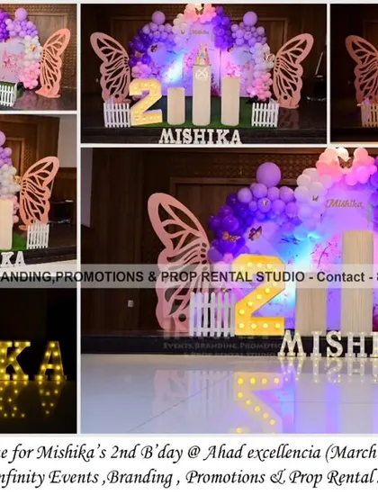 A pretty butterfly theme for a 2nd birthday at Ahad Excellencia. The setup includes a semi-arch backdrop with a purple and pink balloon garland, large butterfly wing props, and a light-up number "2," creating a magical atmosphere.