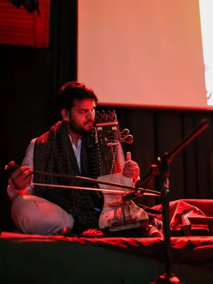 Musician Gandhar performs on the sarangi, blending Indian classical sounds with contemporary music. Our Fête de la Musique stage features a diverse lineup of artists, celebrating Indo-French musical fusion.