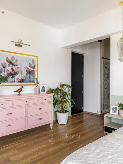 In the 'Tatvam' master bedroom, we played with different shades of green and pink. This pink chest of drawers adds a soft, romantic touch against the two-tone wall.