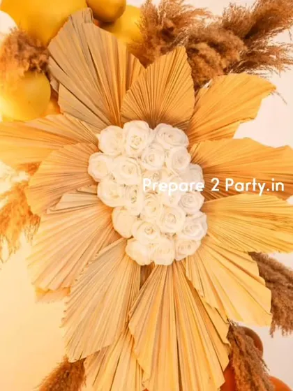 These close-ups of the 60th birthday decor highlight the detailed floral work made of dried palms and artificial roses, and the warm glow of the neon and marquee lights.