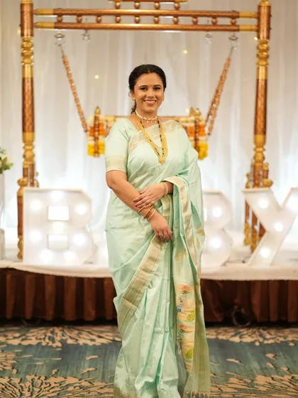 A full-length view of her beautiful pastel saree and traditional jewelry for the naming ceremony, all brought together with my makeup and draping service.