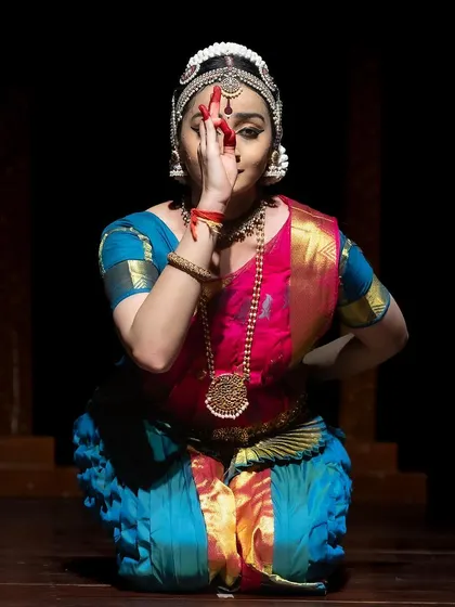 A close-up abhinaya shot from the Kanasu festival, where the expression conveys a mix of coyness and curiosity.