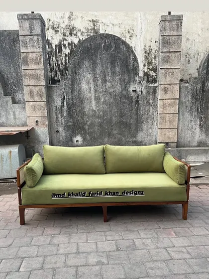 A straight-on shot of the green sofa, ready to become the centerpiece of a stylish living room or lounge.