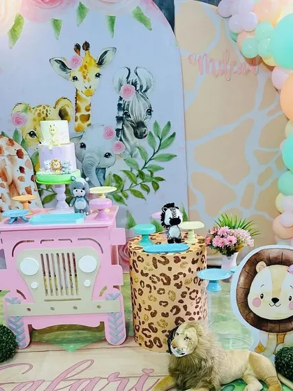 This view of the pastel safari party highlights the soft-colored balloon arch and the friendly lion cutout.