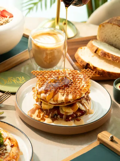 A close-up of the honey pour, highlighting the gooey texture and fresh ingredients.