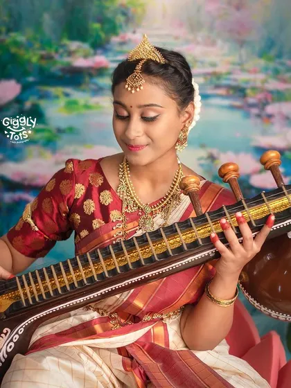 A close-up of a young girl playing the veena in our Saraswati-themed shoot, capturing her focused expression.