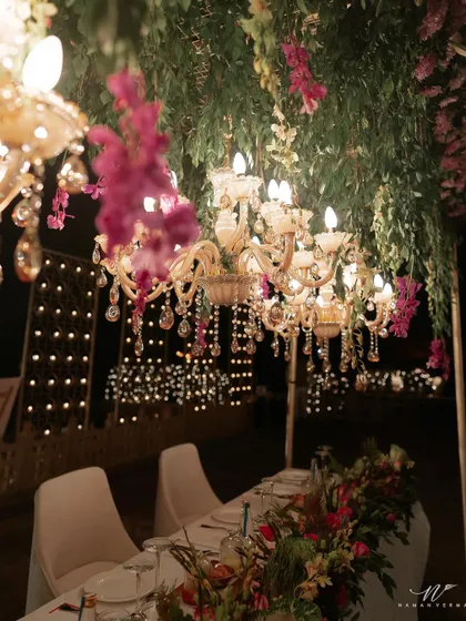 The ambiance at K+G's wedding dinner was pure magic. Crystal chandeliers dripped with fuchsia orchids, casting a warm, romantic light over the long dining tables. It was the perfect, intimate setting for an evening of heartfelt speeches and celebration.