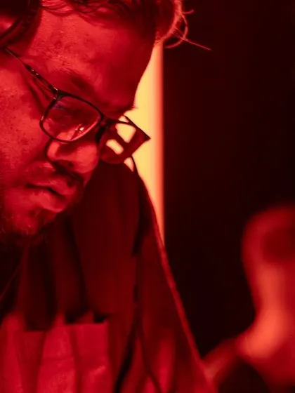 A close-up of me in the red light, completely immersed in the set.