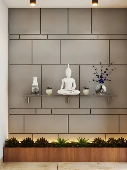 This minimalist foyer features a concrete-finish accent wall with clean geometric lines. A floating shelf holds a serene white Buddha statue, while a built-in planter with uplighting at the base adds a touch of nature and warmth.