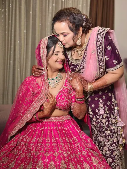 A mother's kiss and blessing. The bride's soft glam makeup is perfect for this emotional and beautiful moment.