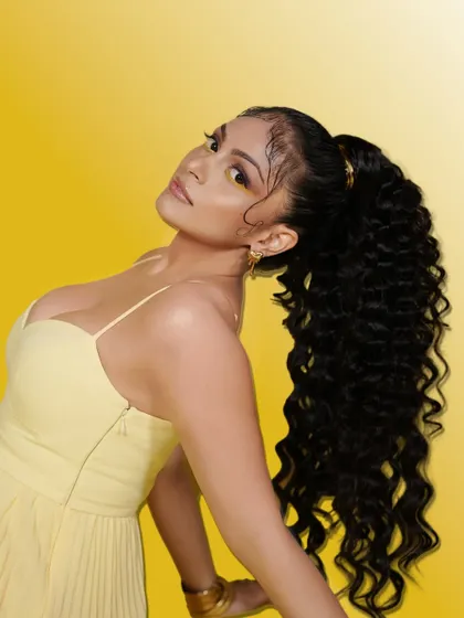 A bold and stylish pose from our Summer Edit. The makeup is flawless and the high ponytail adds a touch of drama, perfect for a high-fashion editorial look.
