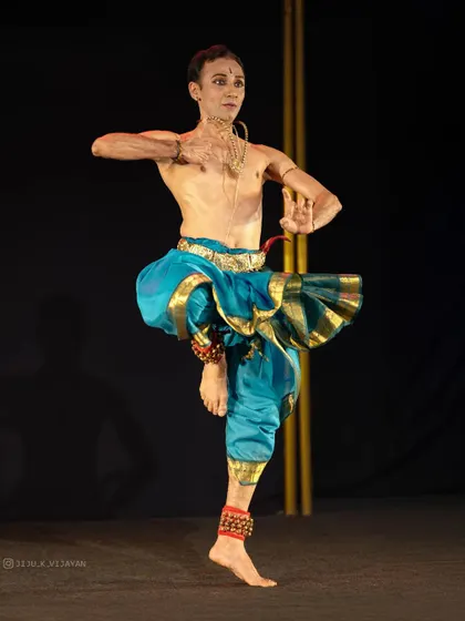 A display of pure form and balance during a solo recital. This posture, held with precision, demonstrates the control and physical discipline required in the art of Bharatanatyam.