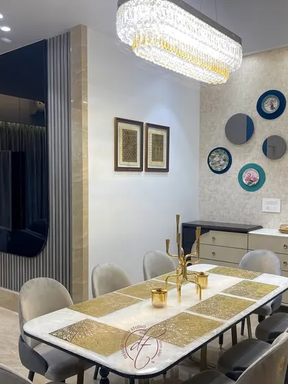 This view shows the dining area's wall decor, featuring a collection of circular mirrors and art plates. The design adds a personal and artistic touch to the space, making it feel unique and curated.