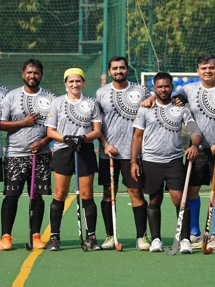 A mixed-gender team poses for a photo, highlighting the inclusive nature of our hockey community. We believe hockey is a sport for everyone.