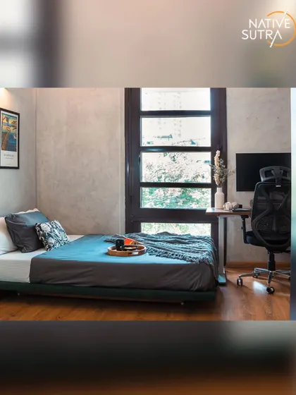 This angle shows the integrated workspace next to the bed, a practical solution for a compact room. The large window ensures the space feels bright and connected to the outdoors.